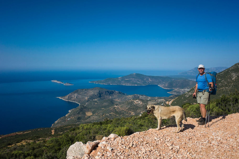 Man hiking with dog in the mediterranean